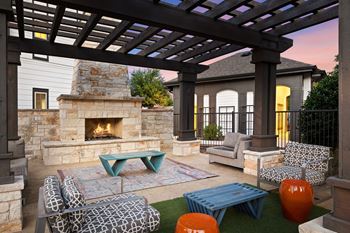 Outdoor lounge with fireplace and comfy seating